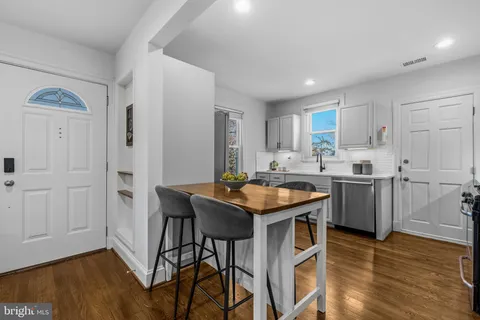 a kitchen with granite countertop a sink a counter top space and stainless steel appliances