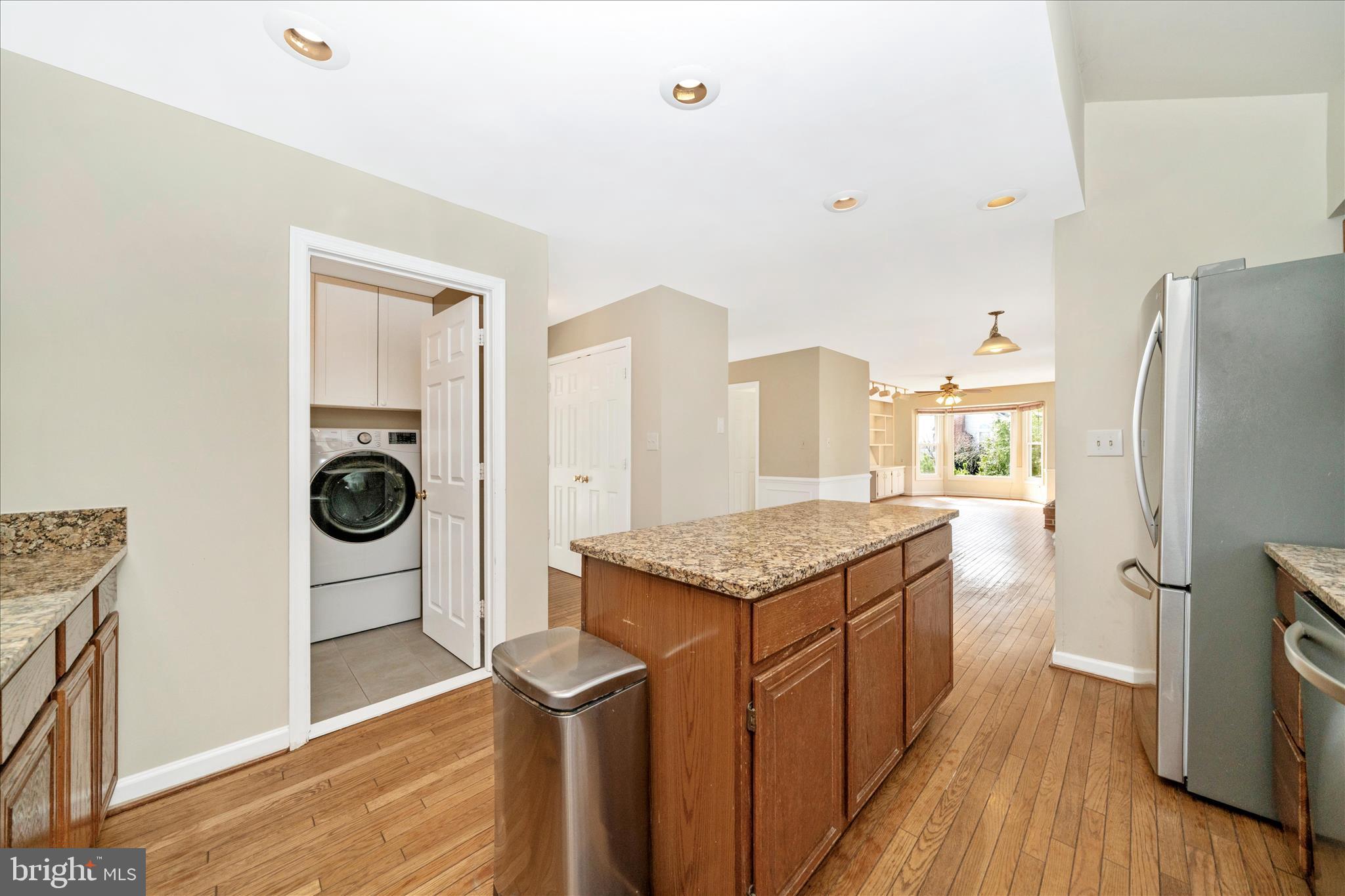 17004 Spates Hill Road Poolesville, MD 20837 - Photo 15 of 67 a kitchen with stainless steel appliances granite countertop a refrigerator a stove and a wooden floors