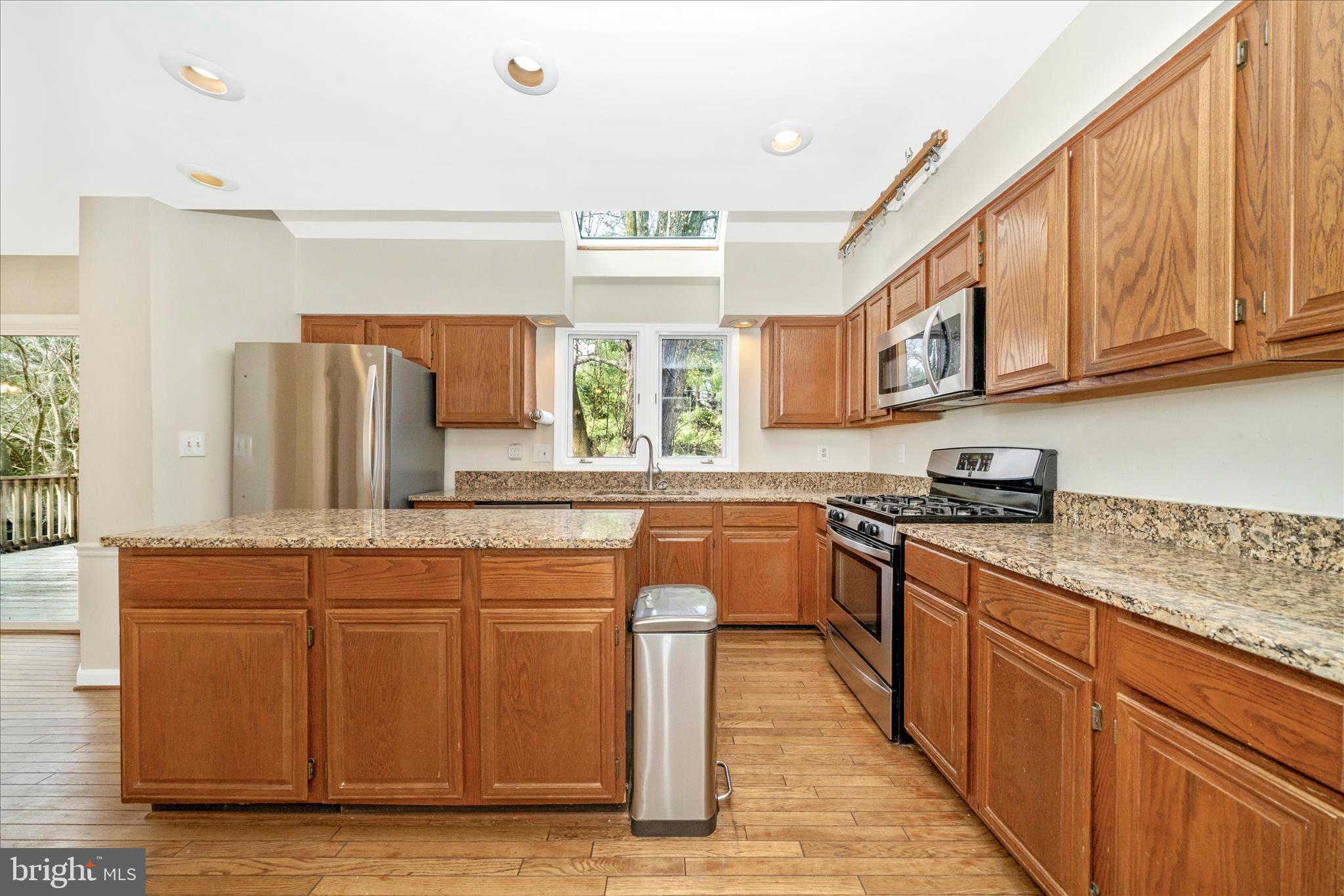 17004 Spates Hill Road Poolesville, MD 20837 - Photo 16 of 67 a kitchen with stainless steel appliances granite countertop wooden cabinets a sink and a stove