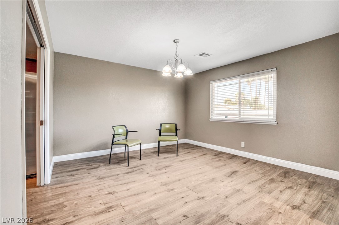 4367 South Mojave Road Las Vegas, NV 89121 - Photo 11 of 53 Natural light filters through the window, illuminating the wood flooring in this versatile space.