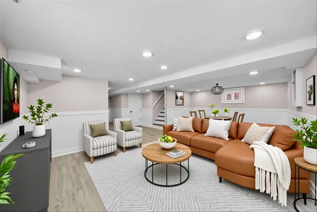 a living room with furniture rug and white walls