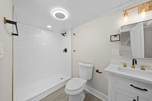 a white toilet sitting next to a bathroom sink