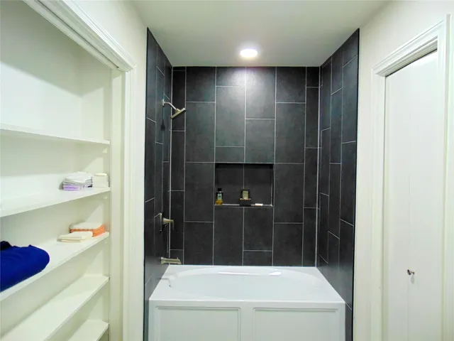 a bathroom with a bathtub and shower