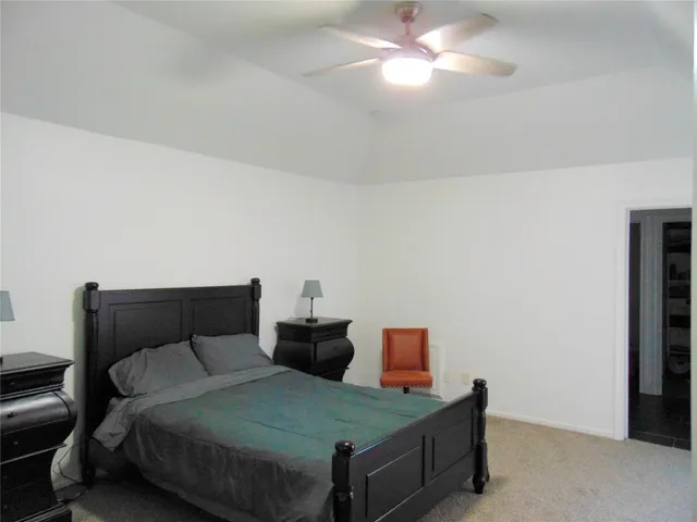 a bedroom with a bed and a table