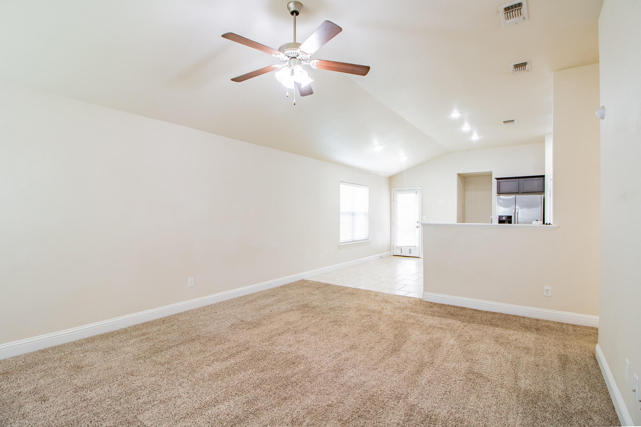 7409 101st Street Lubbock, TX 79424 - Photo 4 of 22 an empty room with fan and windows
