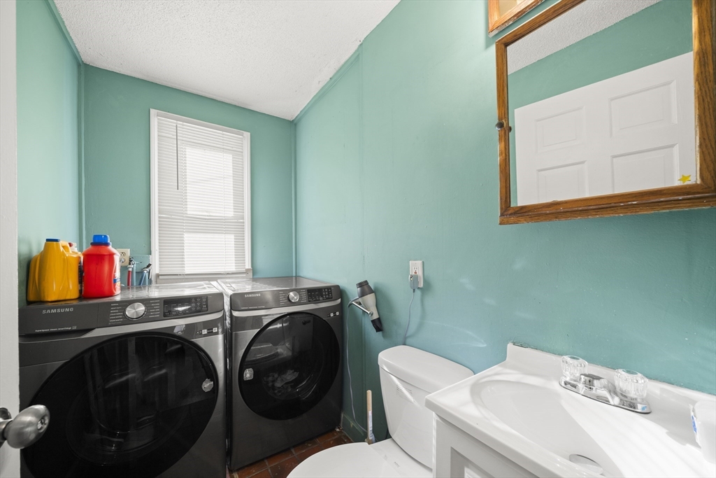 55 Malden Street Springfield, MA 01108 - Photo 15 of 40 a bathroom with a sink a toilet and a window