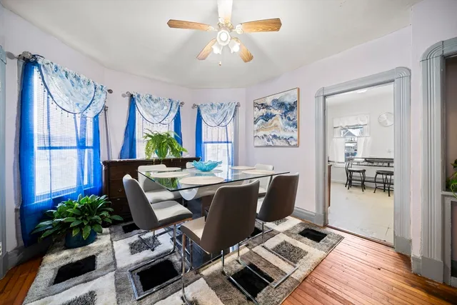 a living room with furniture a chandelier and a window