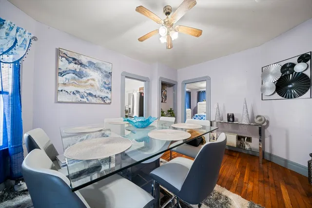 a dining room with furniture a rug and a chandelier