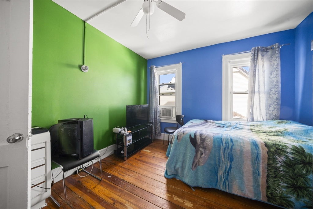 55 Malden Street Springfield, MA 01108 - Photo 19 of 40 a bedroom with a bed and a flat screen tv