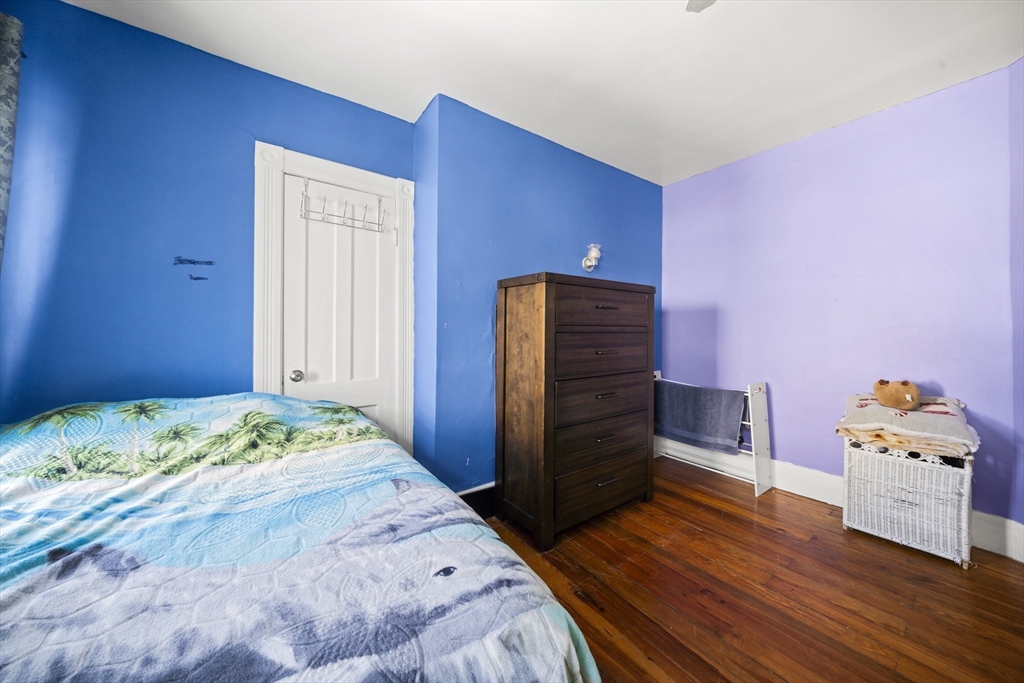55 Malden Street Springfield, MA 01108 - Photo 21 of 40 a bedroom with a bed and a dresser