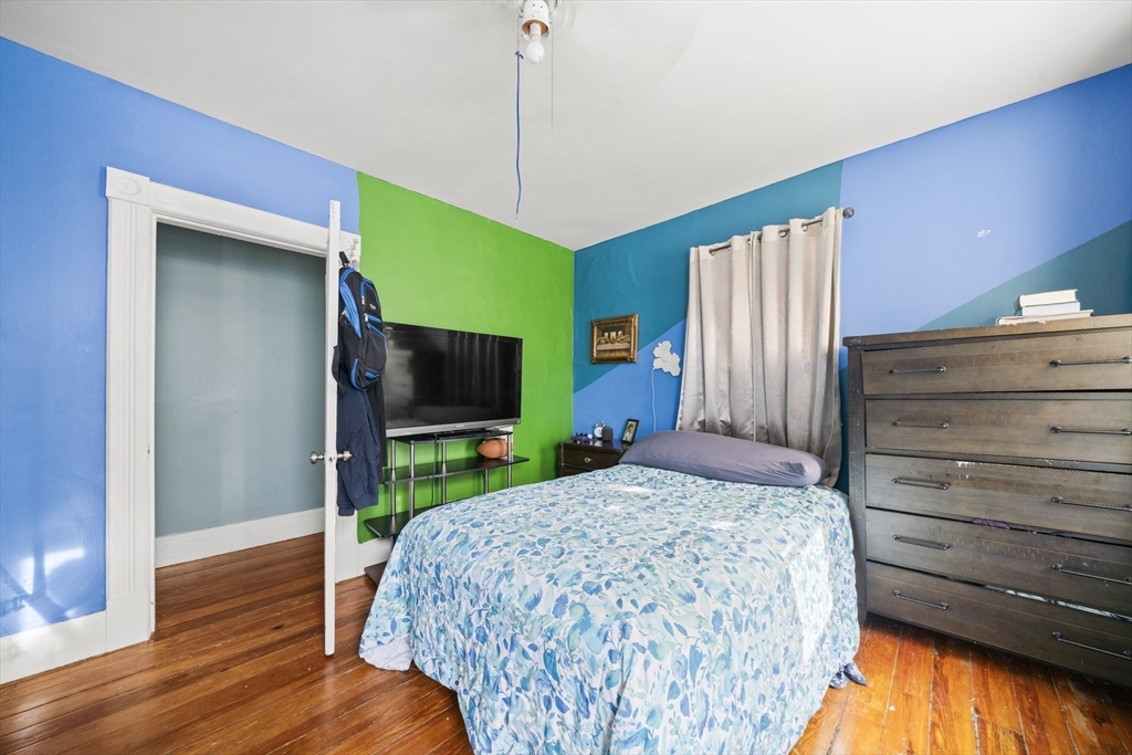 55 Malden Street Springfield, MA 01108 - Photo 22 of 40 a bedroom with a bed and a flat screen tv