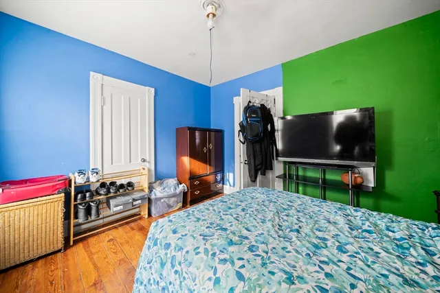 a bedroom with a bed and a television