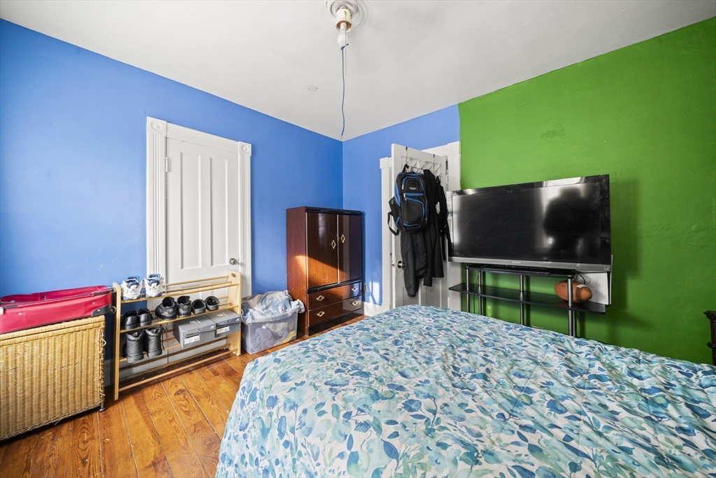 55 Malden Street Springfield, MA 01108 - Photo 23 of 40 a bedroom with a bed and a television