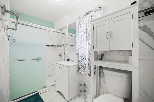 a bathroom with a sink toilet and shower