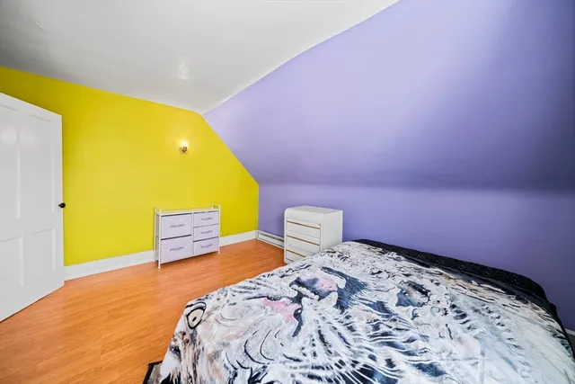 a bedroom with a bed and blue wall in front of it