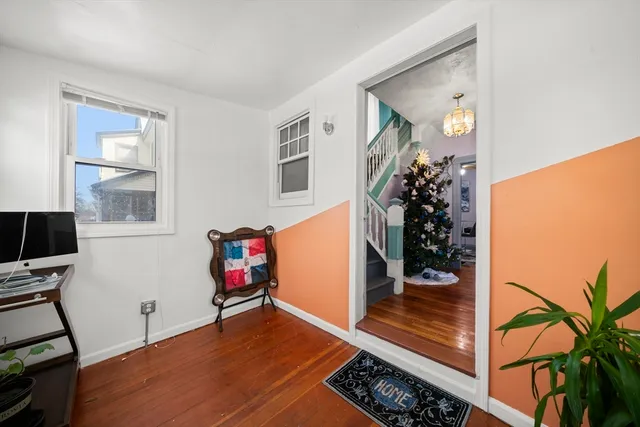 a view of a livingroom with wooden floor and entryway