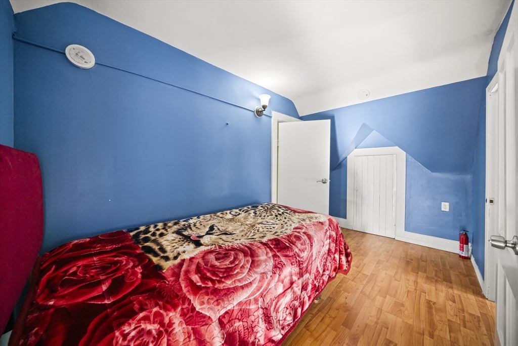 55 Malden Street Springfield, MA 01108 - Photo 31 of 40 a bedroom with a bed and a mirror