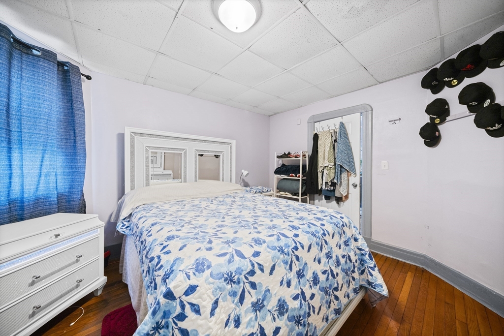 55 Malden Street Springfield, MA 01108 - Photo 10 of 40 a bedroom with a large bed and a dresser