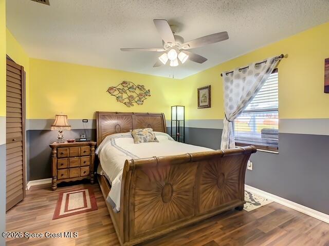 205 Rita Boulevard Melbourne Beach, FL 32951 - Photo 13 of 19 a bedroom with a bed and wooden floor
