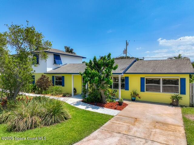 205 Rita Boulevard Melbourne Beach, FL 32951 - Photo 2 of 19 a front view of a house with garden