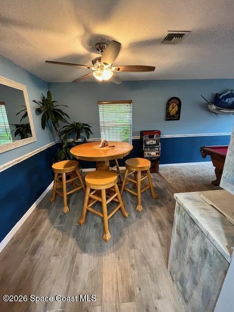 205 Rita Boulevard Melbourne Beach, FL 32951 - Photo 7 of 19 a dining room with wooden floor a chandelier a glass table and chairs