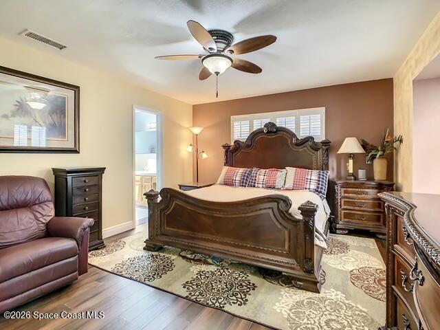 205 Rita Boulevard Melbourne Beach, FL 32951 - Photo 9 of 19 a bedroom with a bed dresser and a ceiling fan