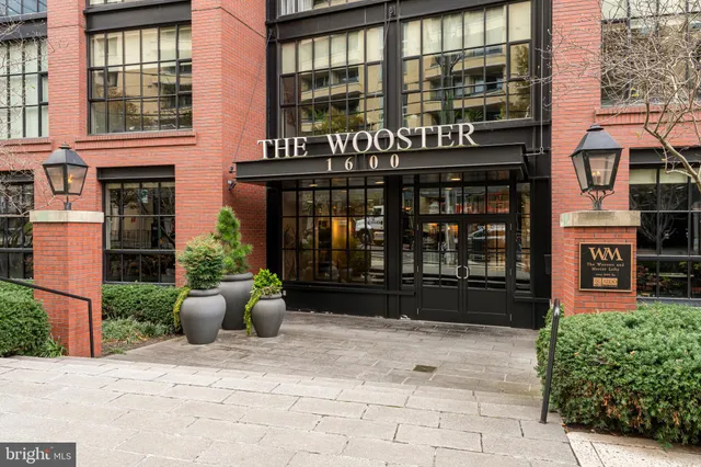 a front view of a building with potted plants