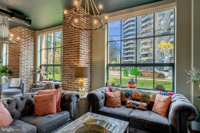 a view of a dining room with furniture wooden floor and chandelier