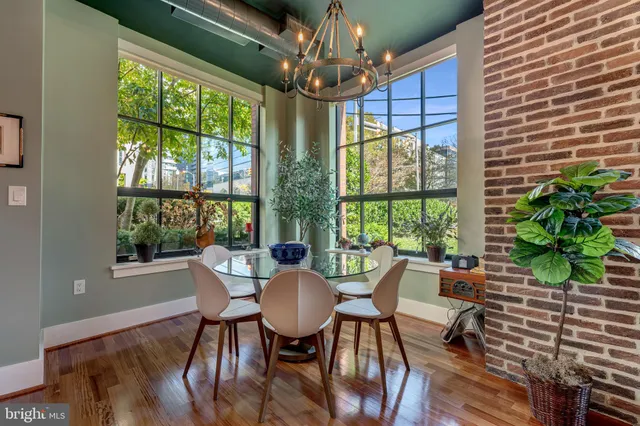 a view of a dining room with furniture window and wooden floor