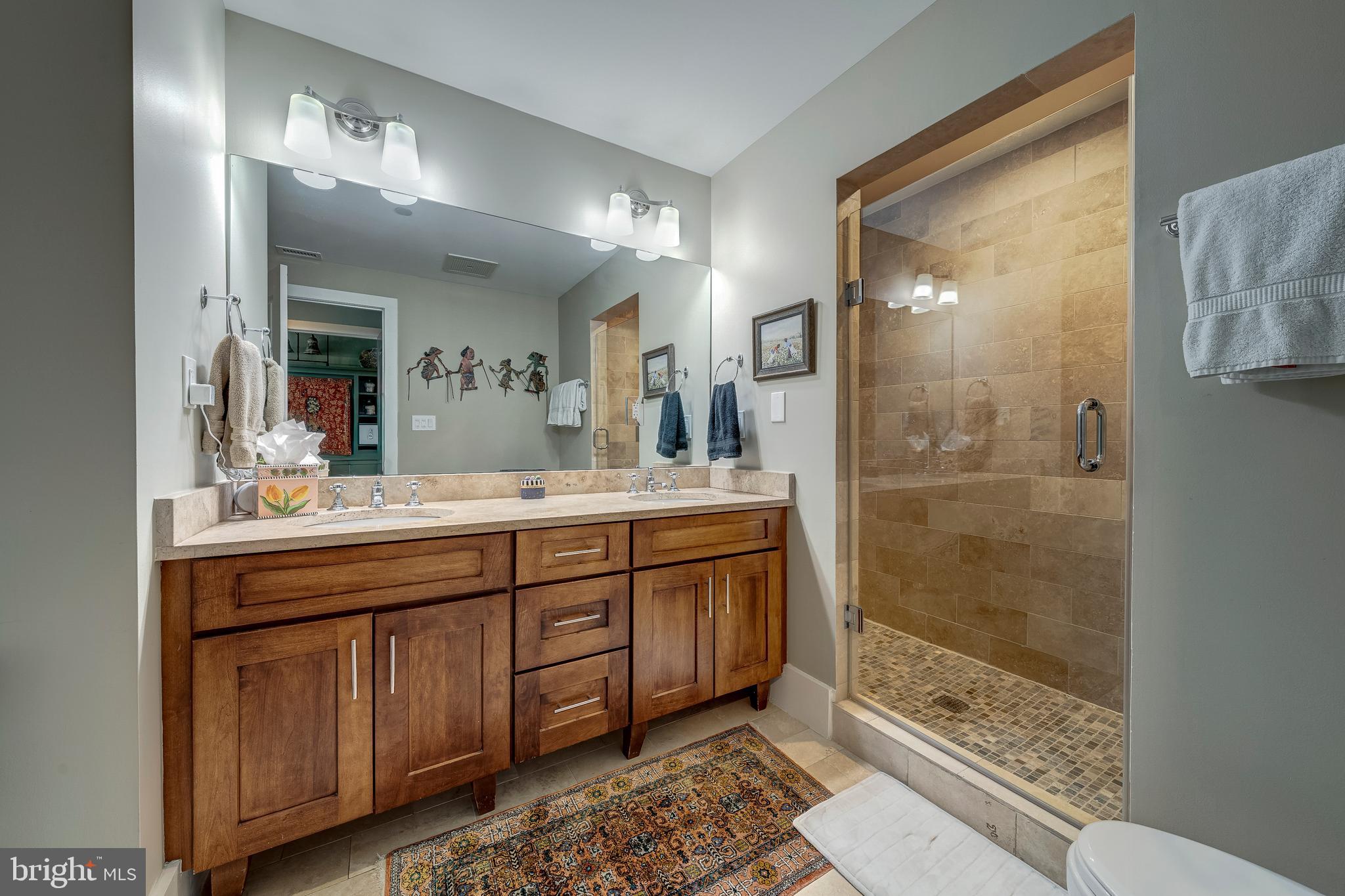 1600 Clarendon Boulevard, Unit W108 Arlington, VA 22209 - Photo 25 of 50 a bathroom with a shower sink and mirror