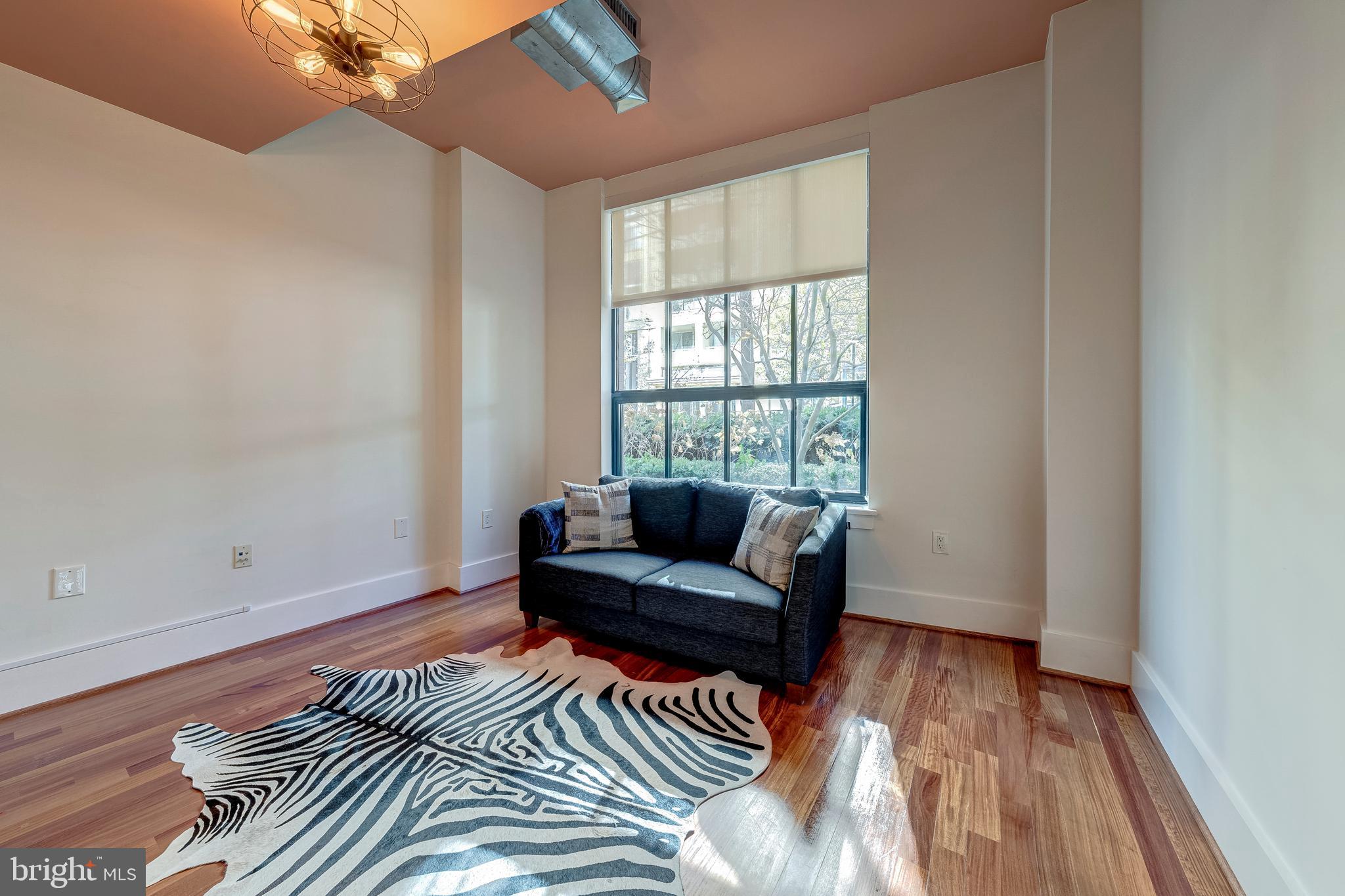 1600 Clarendon Boulevard, Unit W108 Arlington, VA 22209 - Photo 27 of 50 a living room with furniture and a window