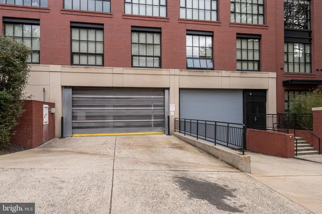 a living room with furniture kitchen and a flat screen tv