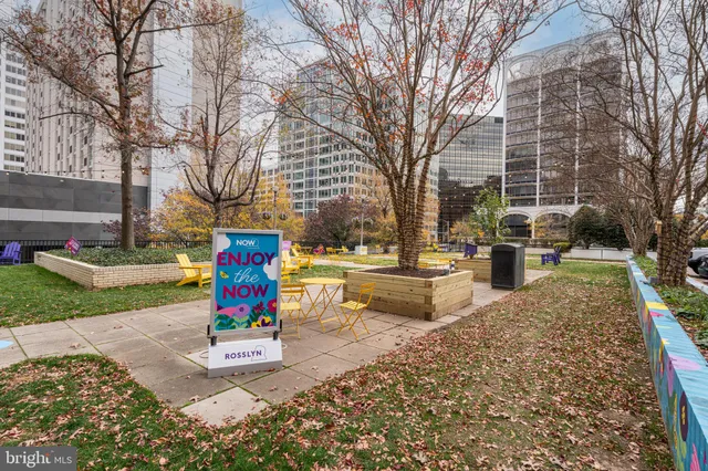 a sign board with buildings in the background