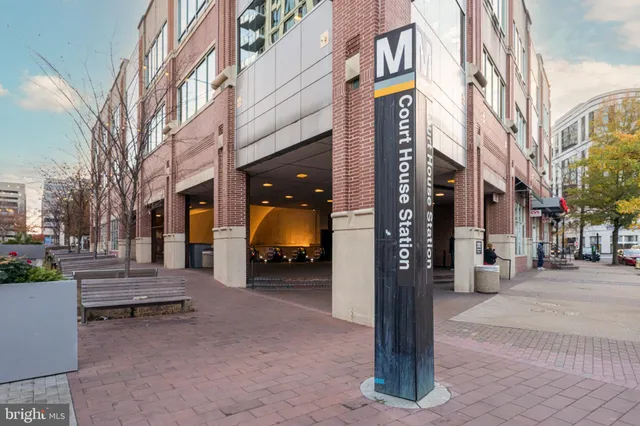 a city street lined with parked cars and buildings