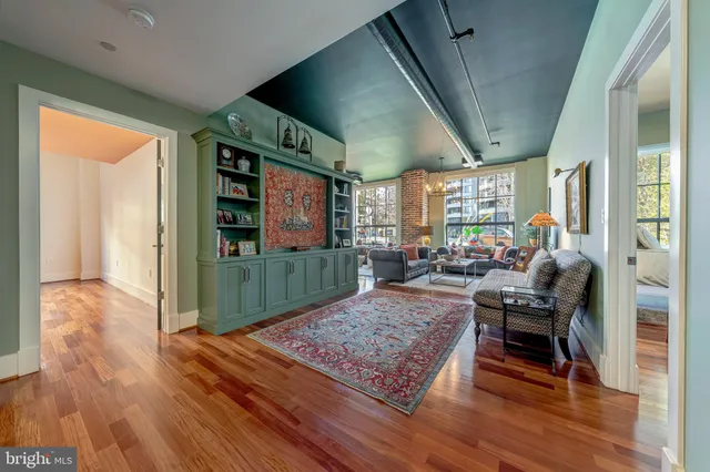 a living room with furniture rug and wooden floor