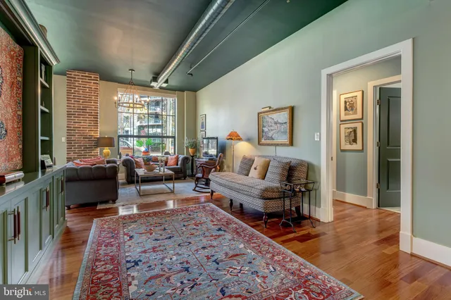a bedroom with furniture and a wooden floor