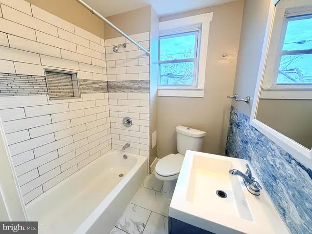a bathroom with a bathtub and a toilet