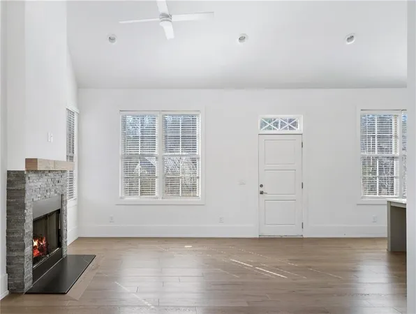 wooden floor fireplace and windows in a room