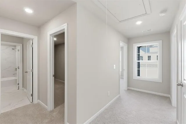 en empty room with windows and bathroom