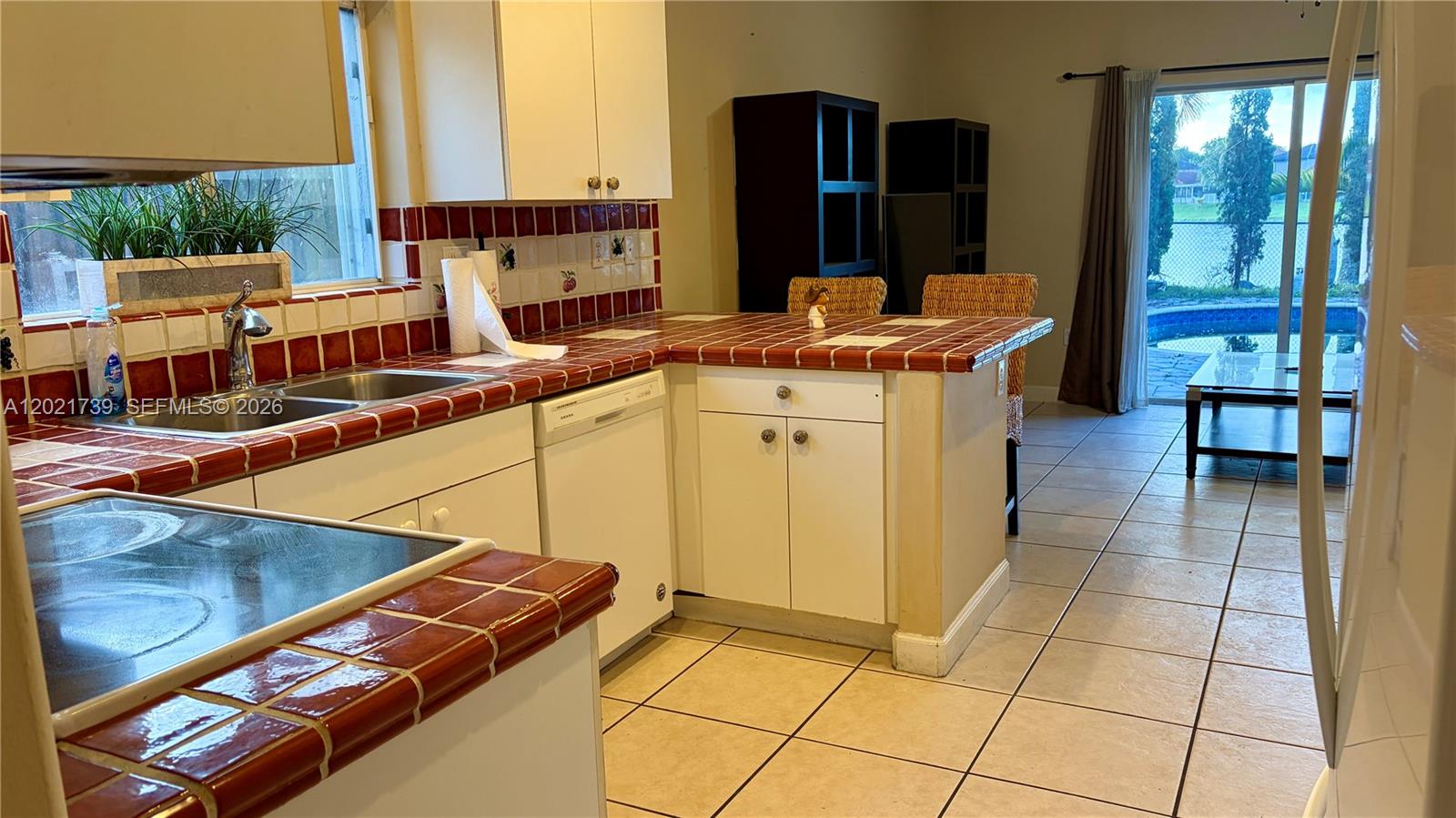 13553 Southwest 124th Avenue Road Miami, FL 33186 - Photo 10 of 31 a kitchen with stainless steel appliances kitchen island granite countertop a sink and cabinets