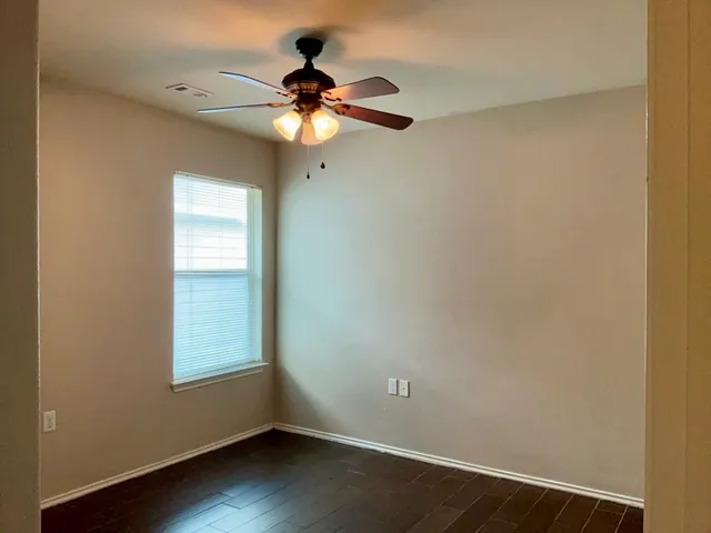 a view of an empty room and wooden floor