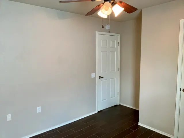 a view of an empty room and wooden floor