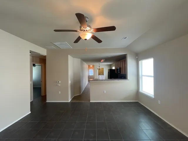 a view of a livingroom with a ceiling fan and window