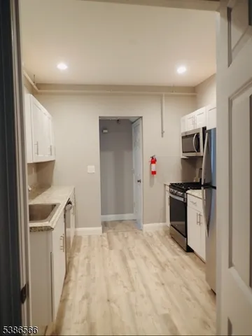 a kitchen with a refrigerator stove and microwave