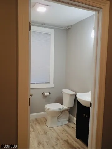 a bathroom with a toilet and a mirror