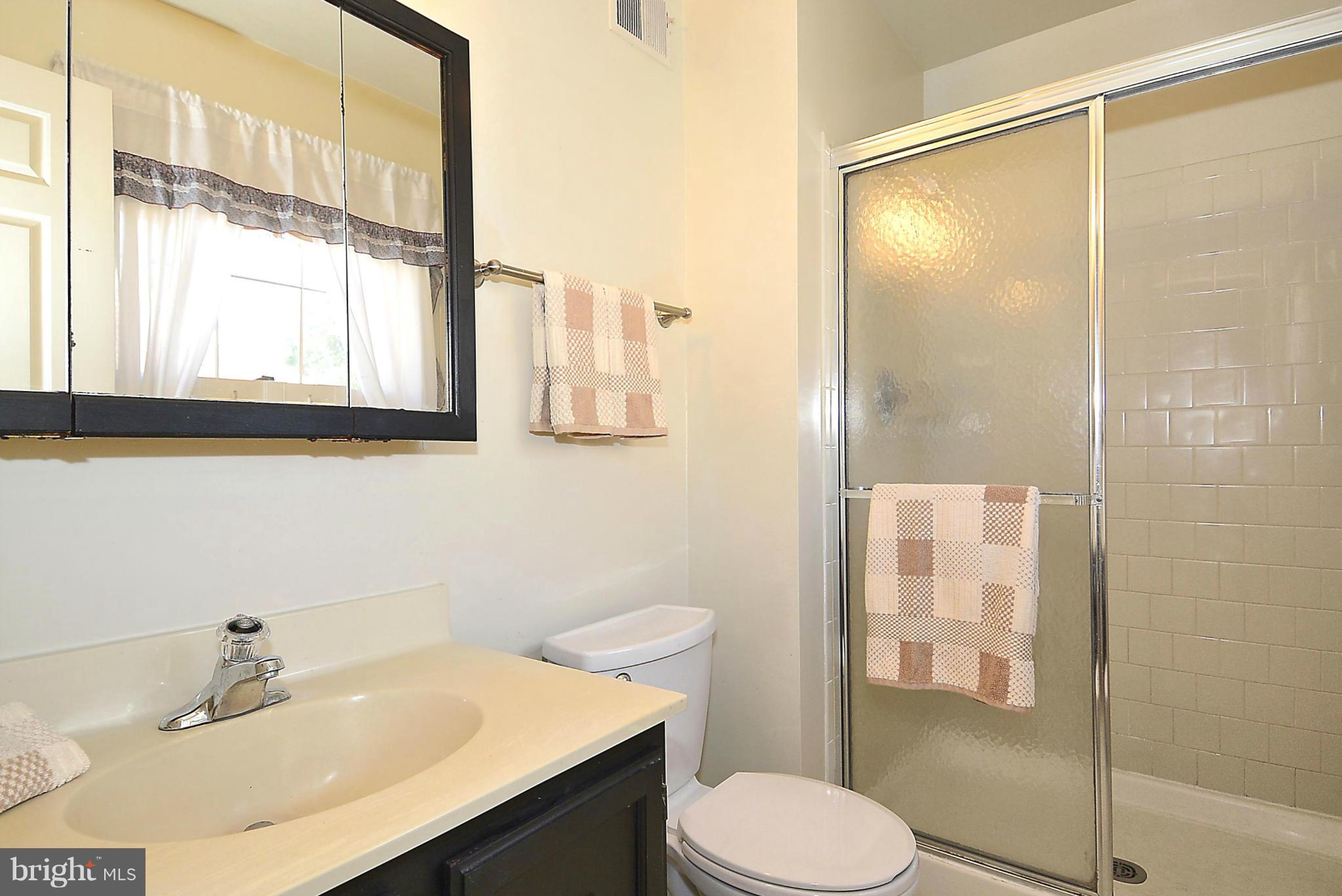 6277 Rathlin Drive Springfield, VA 22152 - Photo 11 of 30 a bathroom with a sink toilet and shower