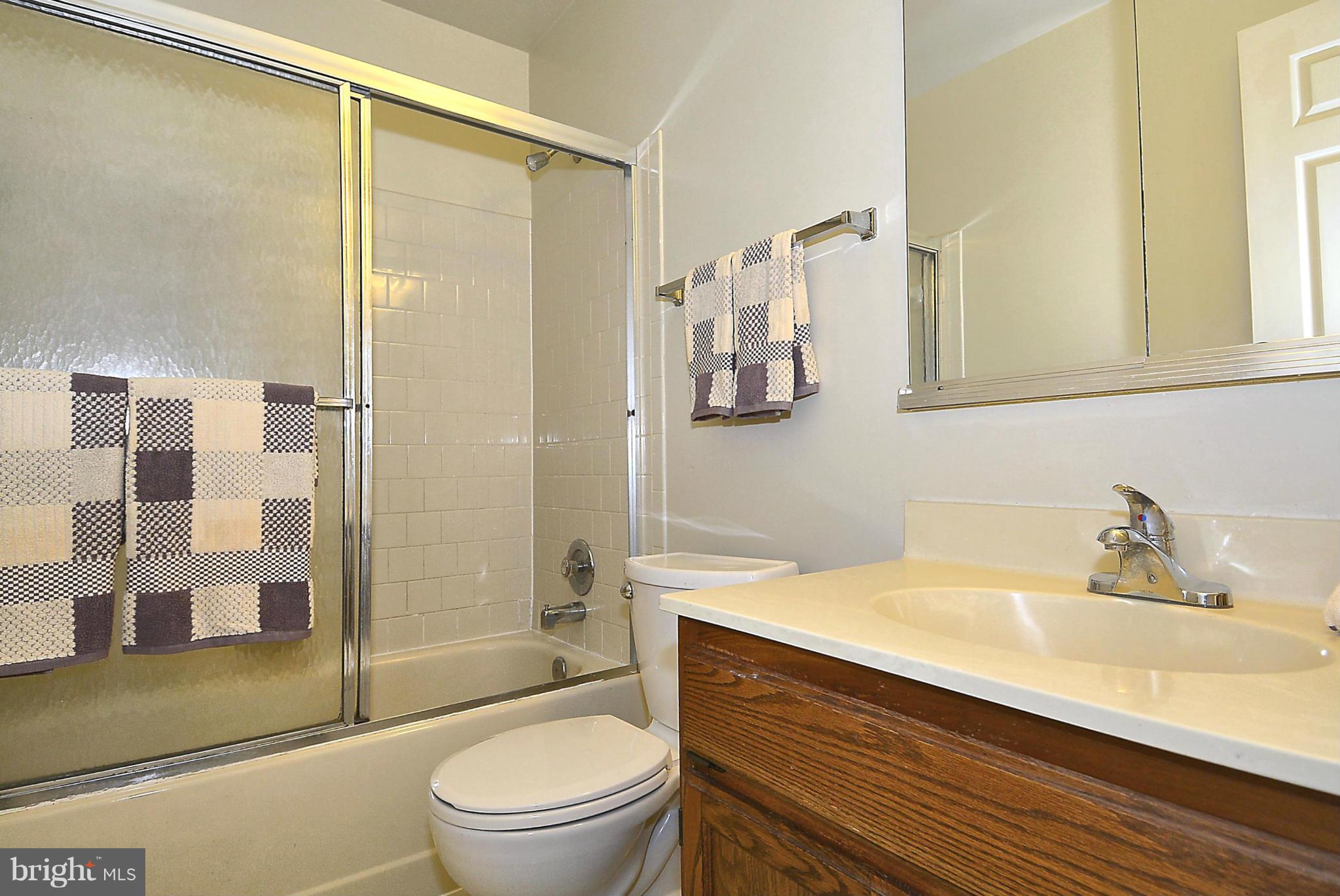 6277 Rathlin Drive Springfield, VA 22152 - Photo 14 of 30 a bathroom with a sink a toilet and shower