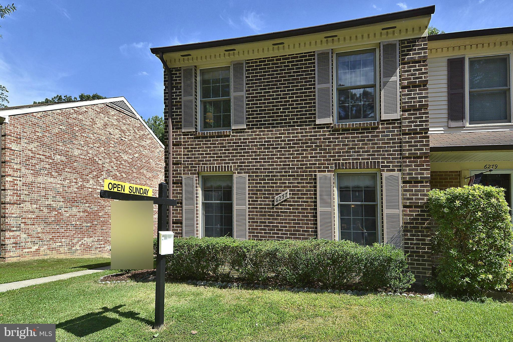 6277 Rathlin Drive Springfield, VA 22152 - Photo 26 of 30 a view of a brick house with a yard and plants