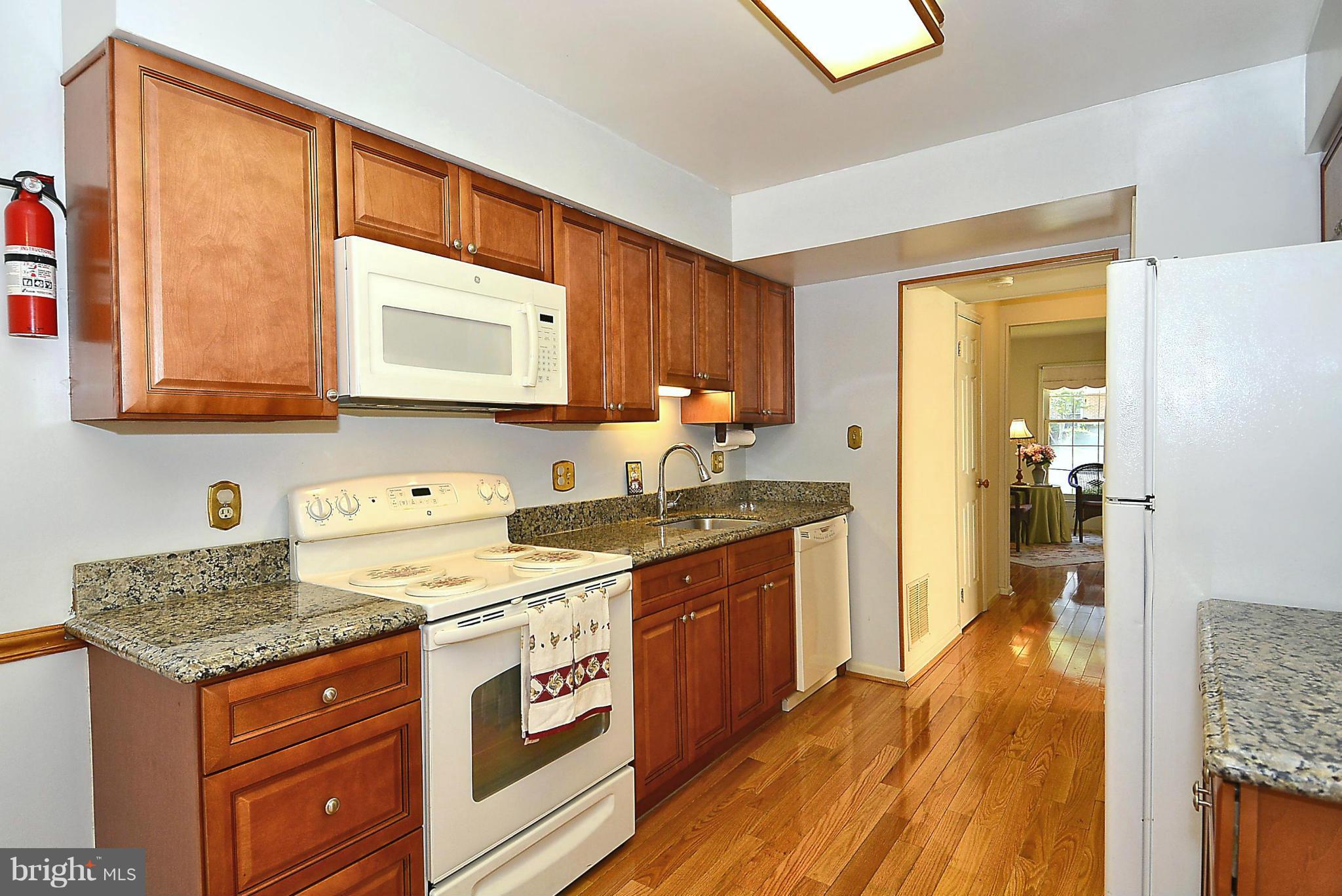 6277 Rathlin Drive Springfield, VA 22152 - Photo 5 of 30 a kitchen with stainless steel appliances granite countertop a stove and a sink