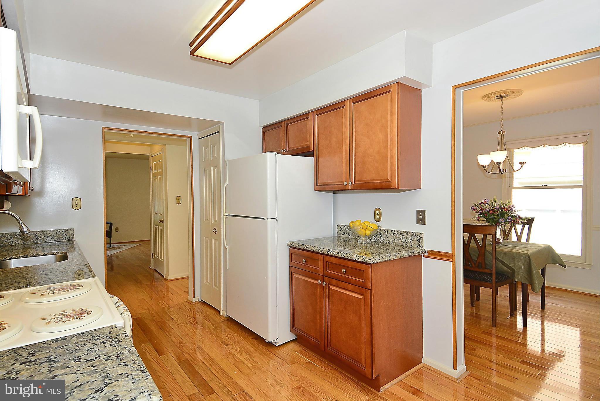 6277 Rathlin Drive Springfield, VA 22152 - Photo 6 of 30 a kitchen with stainless steel appliances granite countertop a stove and a refrigerator
